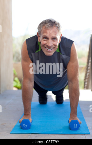 USA, Arizona, Scottsdale, Portrait of senior man doing push-ups Stock Photo