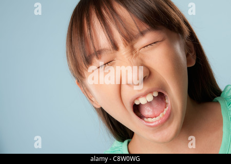 Studio portrait of girl shouting Stock Photo