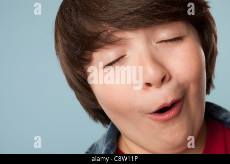 Studio portrait of boy making funny face Stock Photo