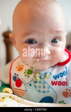Baby Led Weaning - Baby feeding himself Broccoli Stock Photo