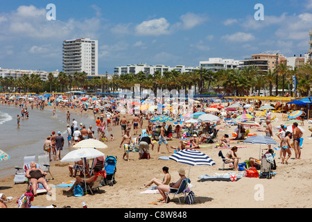 People sunbathing on crowded Llevant beach in Salou, Catalonia, Spain. Stock Photo