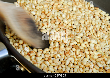 Pine nut kernels being toasted to enhance their flavour before being used. Stock Photo