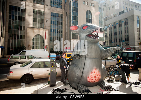 Giant rat balloon at a demonstration in front of the Hospital for Special Surgery in New York Stock Photo