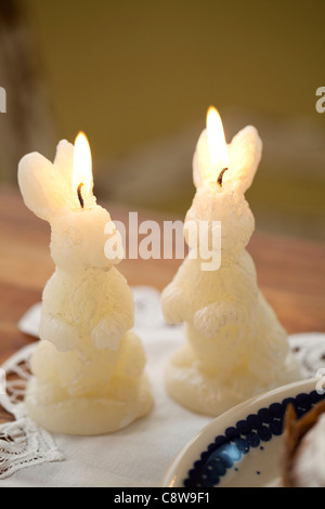 Rabbit Shape Lighted Candle On Desk Stock Photo