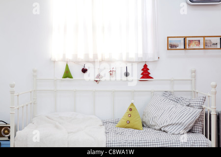Christmas Ornaments Hanging On String Near Window Stock Photo