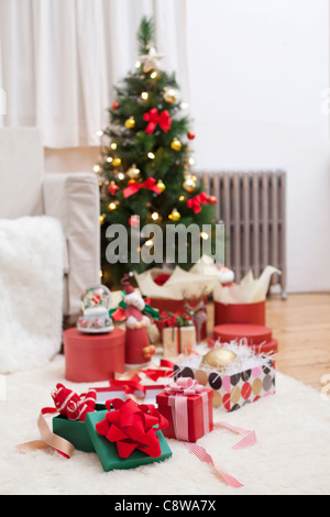 Room Interior With Unwrapped Christmas Gift Boxes And Christmas Tree Stock Photo