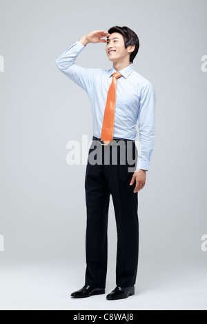 Portrait Of Smiling Asian Businessman Looking Away Stock Photo