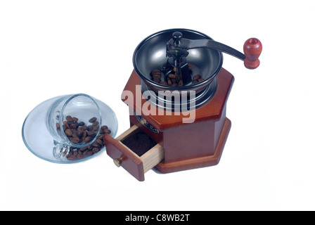 wooden coffee grinder glass cup and grain on white background Stock Photo