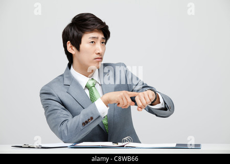 Asian Businessman Worried About Time Stock Photo
