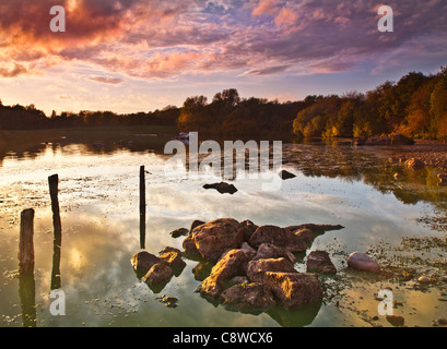 An autumn sunset over the lake at Colwick Country Park, Nottingham, Nottinghamshire, England, UK Stock Photo