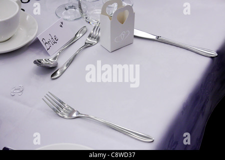 The Bride and Groom place settings and their guests at the head top table on their wedding day, all empty, set up and ready. Stock Photo