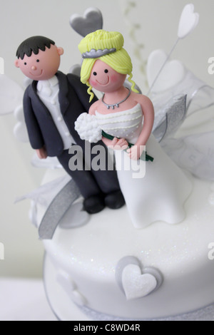 A Bride and Groom wedding cake topper handmade for their three tier heart wedding cake Stock Photo