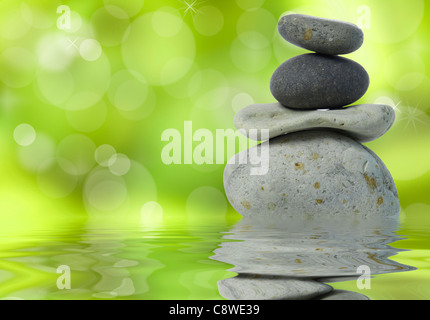 Spa background with stacked stones on a green natural background Stock Photo