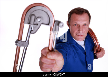 Plumber bending copper piping Stock Photo