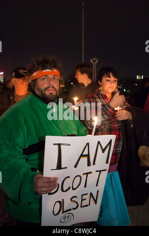 Detroit, Michigan - Members of Occupy Detroit hold a candlelight vigil in support of Occupy Oakland, where activists were calling for a general strike after confrontations with police. A sign remembered Scott Olsen, the Iraq war veteran who was seriously injured by police. Stock Photo
