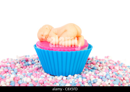 Birth cupcake with marzipan baby and colorful mice sweets over white background Stock Photo