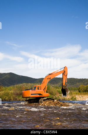 Excavator dredging sediment mud from river Stock Photo - Alamy
