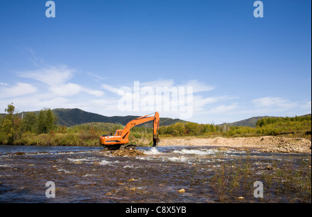 Excavator dredging sediment mud from river Stock Photo - Alamy