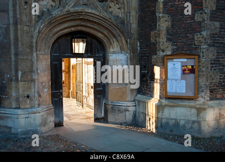 Entrance gateway to Trinity College Cambridge England UK with strong sunlight coming through the open gate. Stock Photo