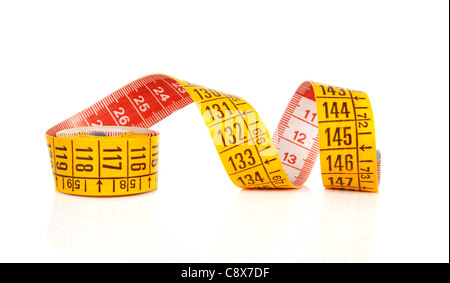 Rolled yellow measure tape over white background Stock Photo