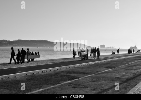 People walking alongside the river, Lisbon, Portugal Stock Photo
