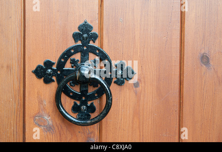 Wrought iron door handle and knocker on a church door in East Molesey, Surrey, UK Stock Photo