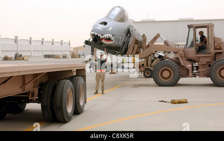 OPERATION IRAQI FREEDOM -- Master Sgt. Mark Kellie guides a flatbed truck into position for loading an A-10 Thunderbolt II fuselage. The aircraft received severe battle damage during a combat mission over Iraq in April and will be shipped back to the United States for repair. Stock Photo