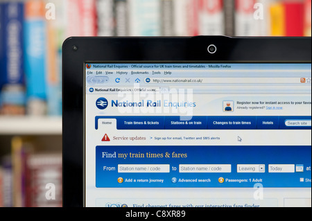 The National Rail website shot against a bookcase background (Editorial use only: print, TV, e-book and editorial website). Stock Photo