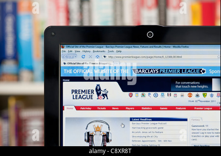 The Premier League website shot against a bookcase background (Editorial use only: print, TV, e-book and editorial website). Stock Photo
