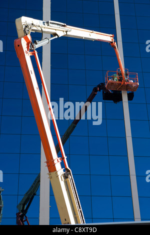 Building cleaner cleaning external glasses windows of building Mallorca Balearic Spain Stock Photo