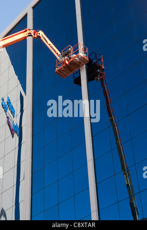 Building cleaner cleaning external glasses windows of building  Mallorca Balearic Spain Stock Photo