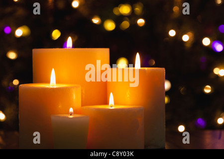 USA, Illinois, Metamora, Close up of burning candles and Christmas lights in background Stock Photo