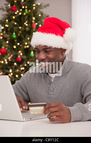 USA, Illinois, Metamora,  Man in Santa hat using laptop Stock Photo