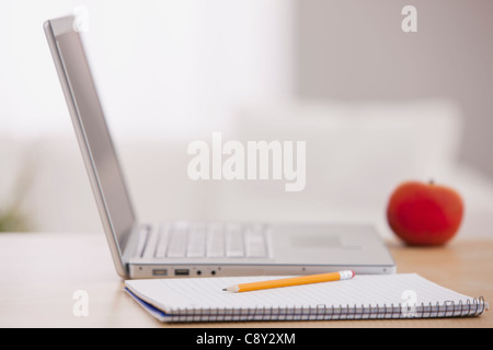USA, Illinois, Metamora, Open laptop, notebook and pencil on desk Stock Photo