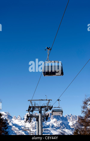 Ski lift chairs on bright winter day in Trentino, Italy Stock Photo