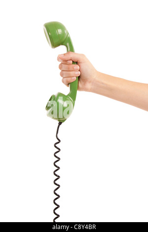 Female hand holding a green earphone from a vintage telephone Stock Photo