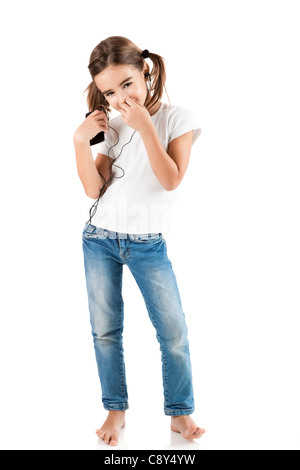 Little girl listen music with a MP3 player, isolated on white Stock Photo