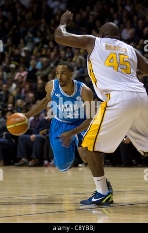 London Ontario, Canada - November 4, 2011. Darrin Dorsey (28) of the Halifax Rainmen drives around Shawn Danies (45) of the London Lightning. London won the game 118-110 in front a crowd of 3600 spectators. Stock Photo