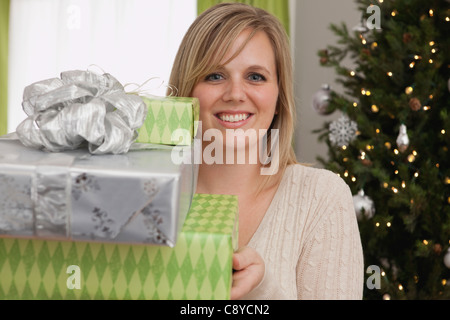 USA, Illinois, Metamora,Woman holding stack of gifts Stock Photo