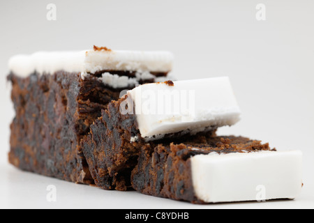 Sliced block of Christmas fruit cake with iced topping Stock Photo