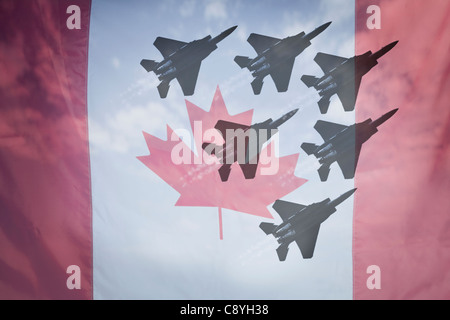 Close-up of Canadian flag with silhouettes of F-16 airplanes Stock Photo