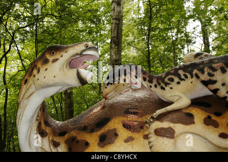 Deinonychus attacks Iguanodon in Leba Park (dinosaur theme park), Poland Stock Photo