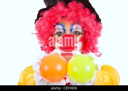 funny clown holding color balls (isolated on white) Stock Photo