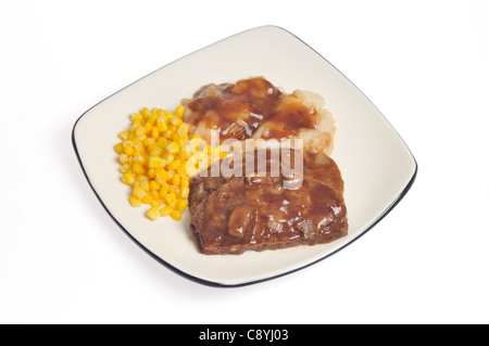 Slice of cooked meatloaf meal with mushroom gravy, mashed potatoes and sweet corn on white plate on white background, cutout. Stock Photo