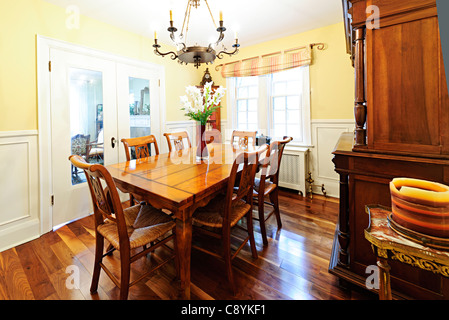 Dining room interior with wooden table and chairs in house
