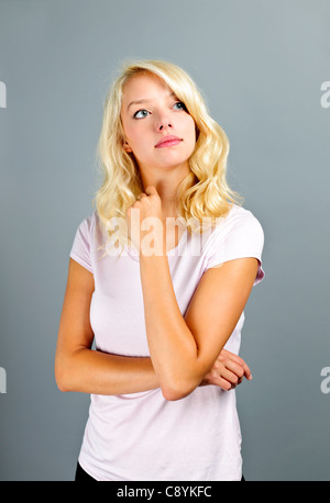 Portrait of thoughtful young caucasian woman looking up Stock Photo