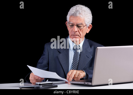Senior businessman working on some documents at his office Stock Photo