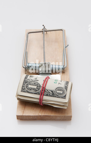 several dollar bills with elastic band set on a mouse-trap Stock Photo