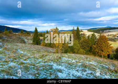 October Carpathian mountain plateau with first winter snow and autumn colorful foliage Stock Photo