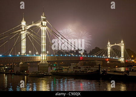 Fireworks explode during Battersea Park Fireworks Display celebrating Guy Fawkes Night in London, UK, on 05 November 2011 with the Albert Bridge and river Thames in foreground. Stock Photo